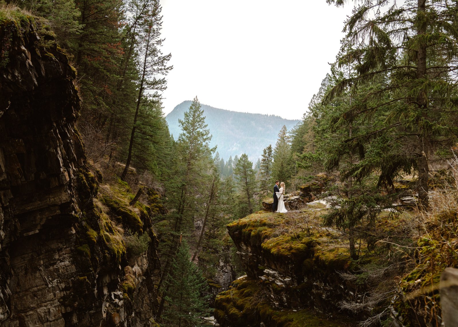 bride and groom taking photo at a Canyon in Cranbrook BC